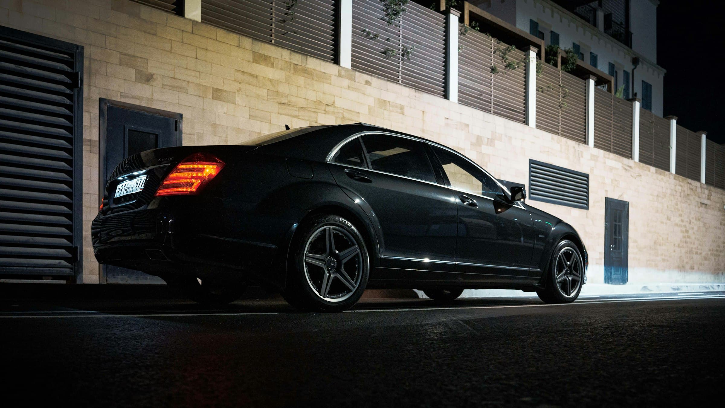 A luxury sedan parked at night on a quiet Los Angeles street